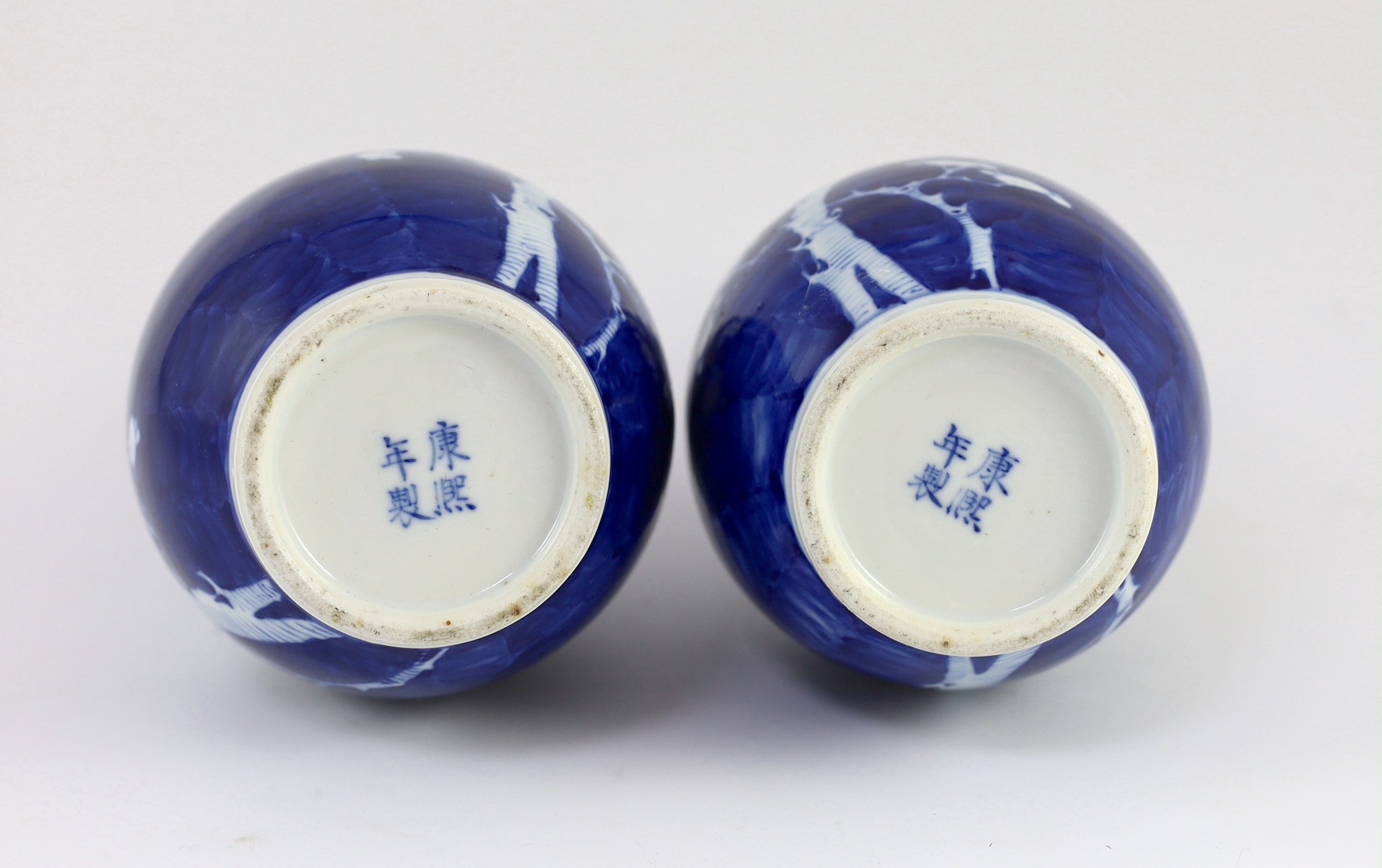 A pair of Chinese blue and white prunus bottle vases, early 20th century, 26cm